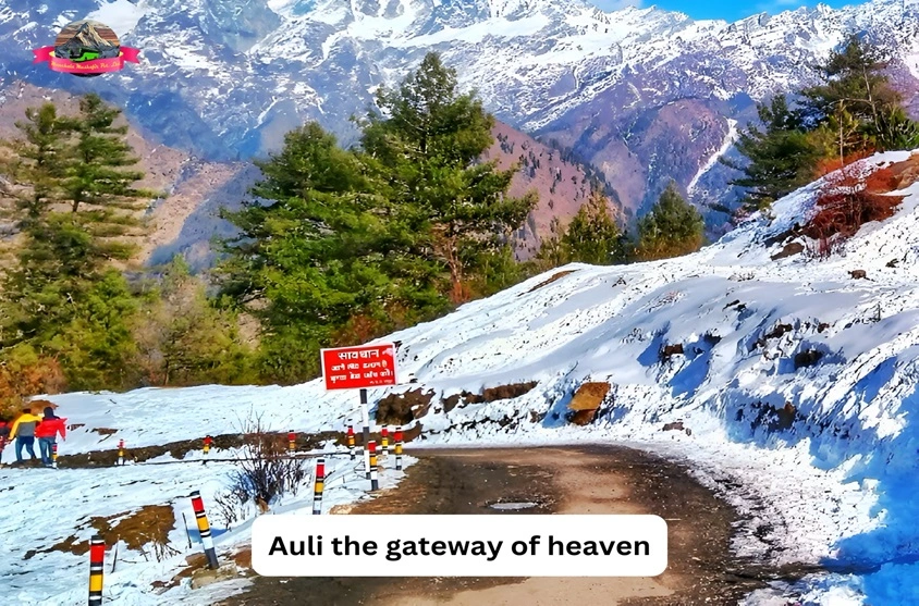 Roads of auli fully covered in a snow with a text auli the gateway of heaven