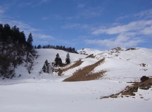 Snow capped bugyals and mountains at Harsil balley depicting best time to visit Harsil valley