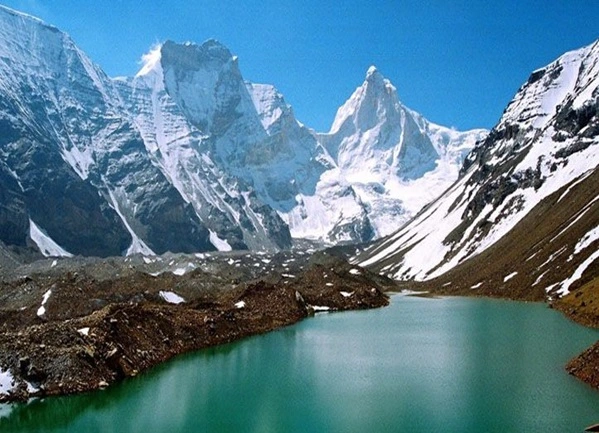 Snow capped mountain, dense forest and beautiful river perfect for trekking in Harsil valley