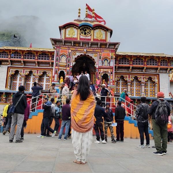 Customers posing outside the Badrinath temple after completing their Char Dham yatra package with Manchala Mushafir