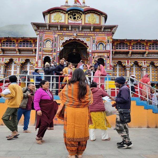 Devotee on Char dham yatra praying to lord vishnu at Badrinath Temple