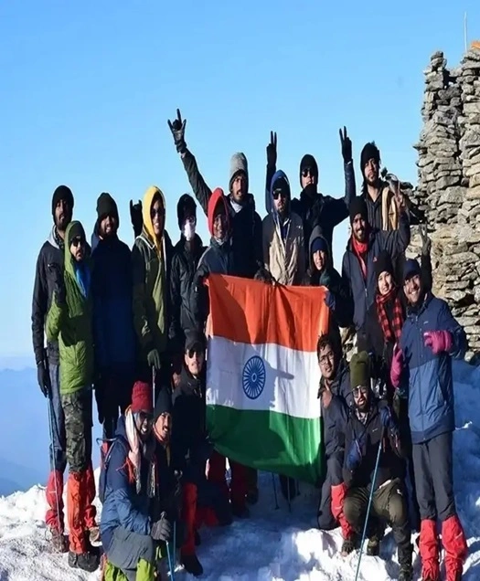 people holding indian flag on kedarkantha trek