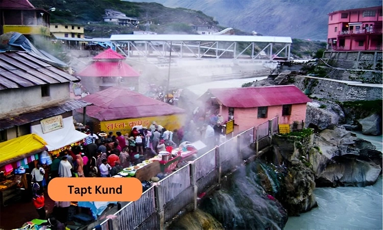 Beautiful image of water vapour coming out of tapt kund with the snow covered mountain at the background